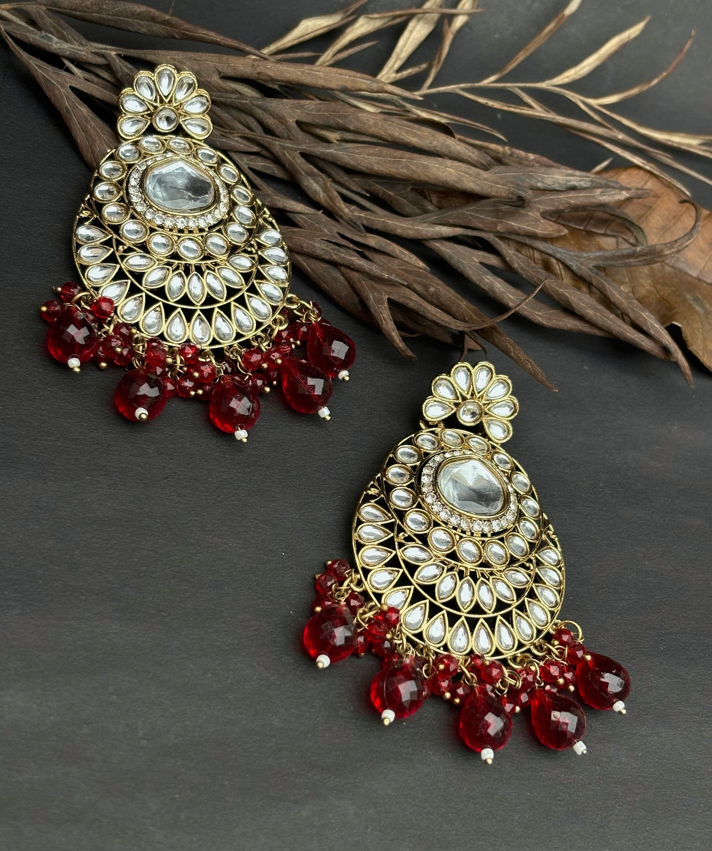 A beautiful traditional Kundan Earring with red beads by hvjewellery.in