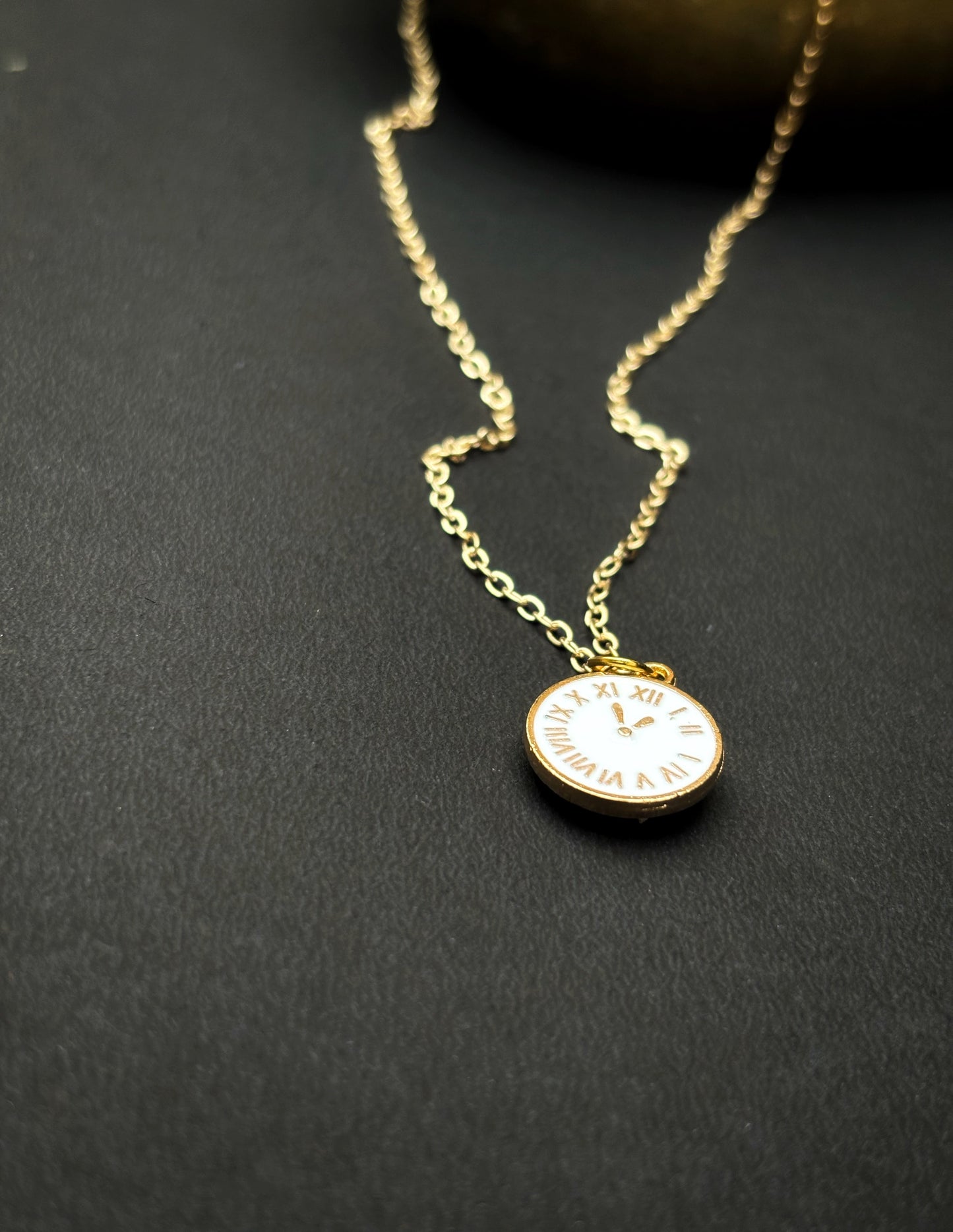 A pendant with a white clock on by hvjewellery.in