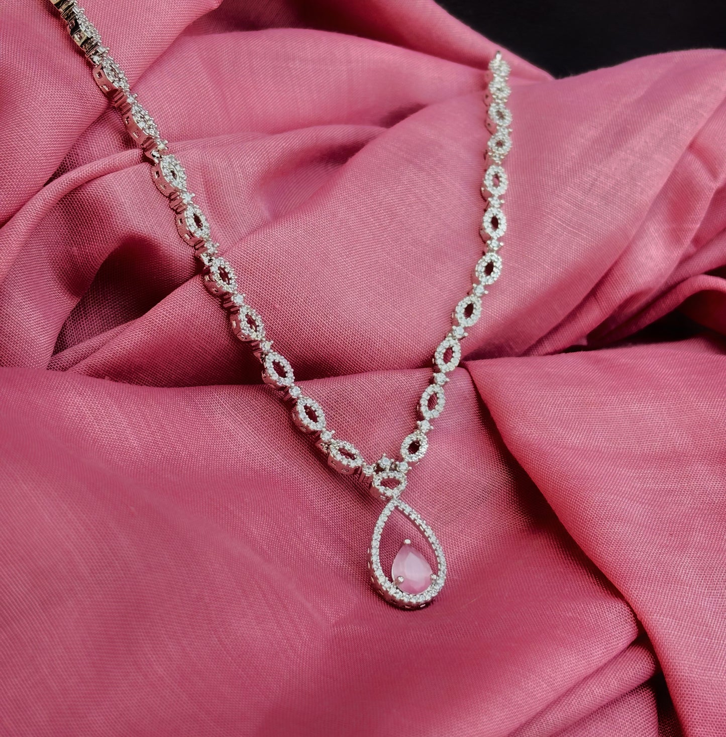 A diamond necklace with pink earring by hvjewellery.in