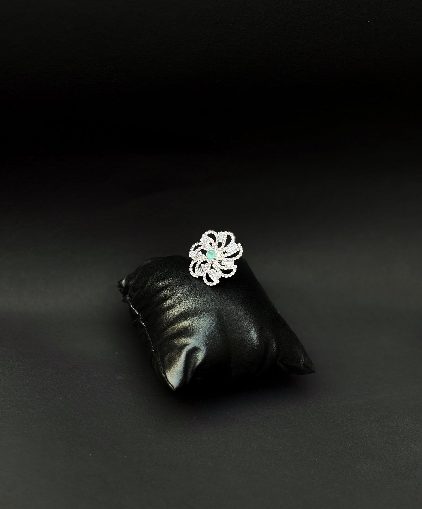 A diamond ring with a light Green stone by hvjewellery.in