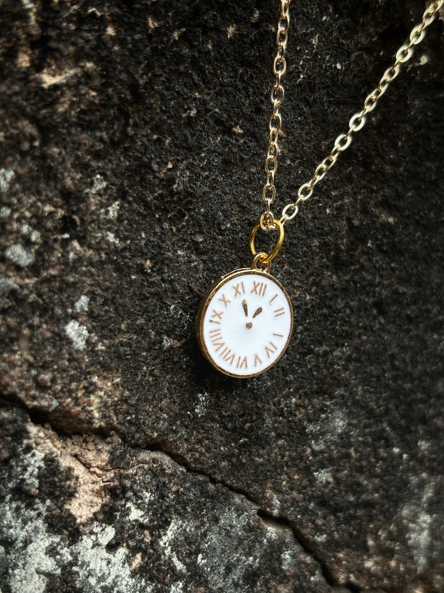 A pendant with a white clock on by hvjewellery.in